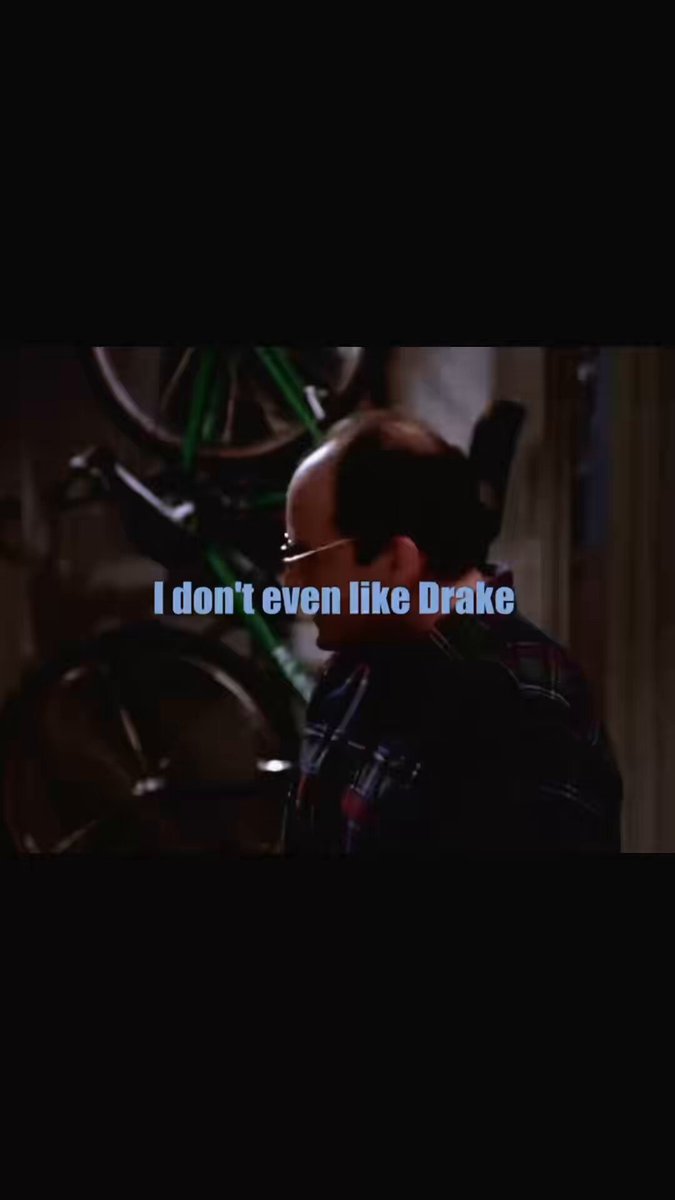 The image features a man wearing glasses, standing next to two bicycles. The caption below the image reads "I don't even like Drake", which seems unrelated to the main subject of the photo or the caption itself.