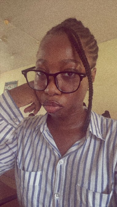 A woman with long braids, black-rimmed glasses, and a blue and white striped shirt rests her chin on her hand, giving the camera a tired, unimpressed look. Her drowsy expression perfectly captures the "I woke up too late for the MoonPay update" mood of the post.