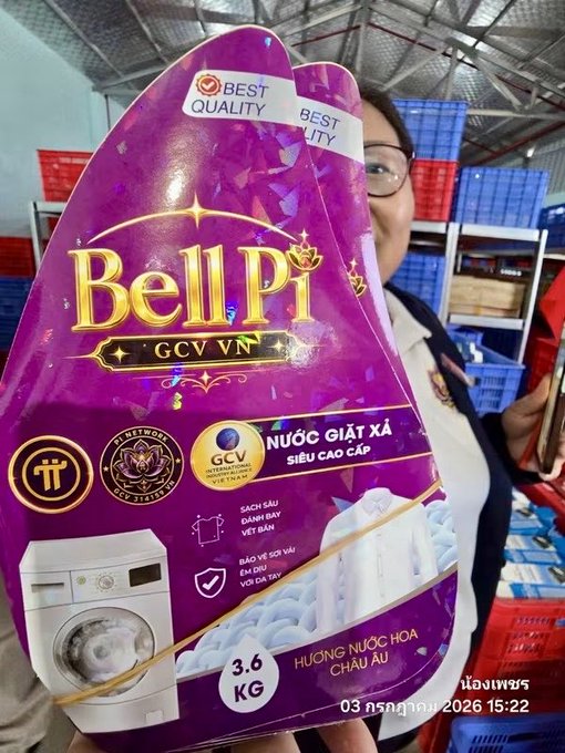 A person holds up a 3.6 KG purple pouch of Bell Pi fabric softener (Nước giặt xả) in a retail store, with labels indicating 'Best Quality' and GCV VN international standard certification.