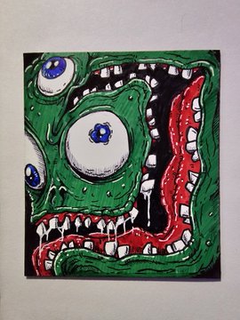 A colorful, grotesque illustration of a green creature with large bulging eyeballs and a wide, toothy grin dripping with saliva, outlined in black against a white background.