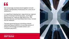 The image features a building in front of which two columns can be seen, one made of glass and the other made of concrete blocks. The photograph captures this building from an angle that emphasizes its height and presence as well as showcases the surrounding city skyline in the background. In the foreground on top right corner of the photo, there is a quote by someone about banks sharing resources for better services with other banks. This quote suggests that the image's focus might be the architecture or design aspect of the building rather than the content displayed at the bottom left corner.
