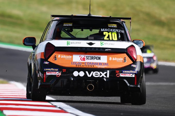 Rear view of a Mini Cooper race car #210 driven by Mackenzie, featuring sponsor decals including BTCPay, Bitcoin, Scorpion, Legal & Commercial Solutions, and vexl on the rear bumper.