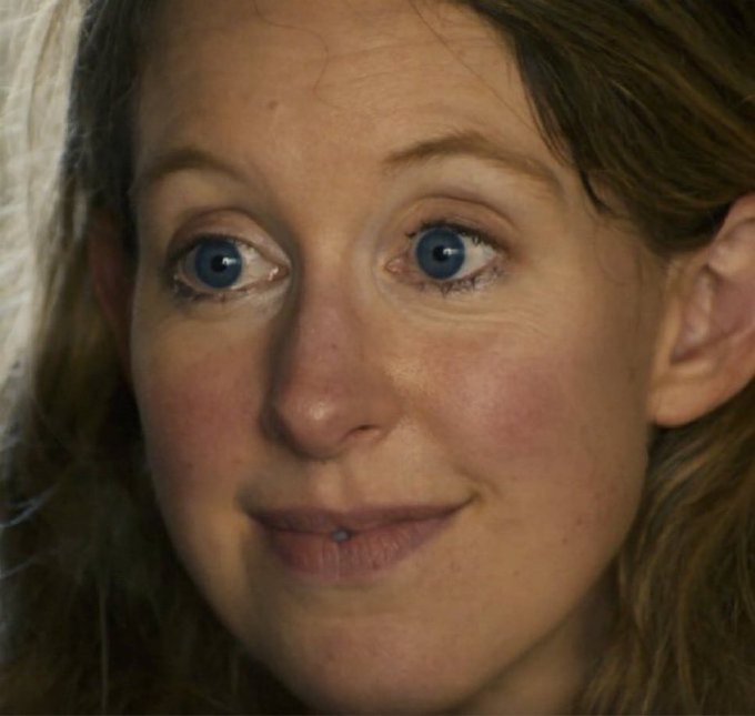 A close-up photo of a wide-eyed, slightly bewildered woman with a subtle smile, conveying a mix of surprise and quiet judgment. Her expression fits perfectly with the post's playful jab at neglected NFTs, as if she's the artwork itself staring back in disbelief.