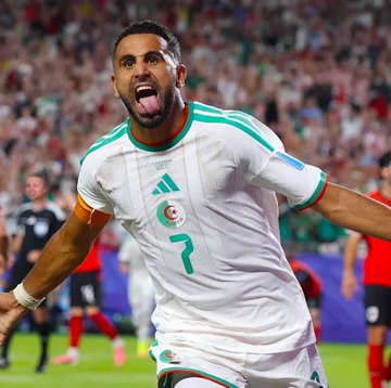 An Algeria soccer player wearing the number 7 jersey celebrates passionately on the pitch, tying into a trader's lucky bet on a 3-3 draw between Algeria and Austria that turned $134 into over $22,000 on Polymarket.