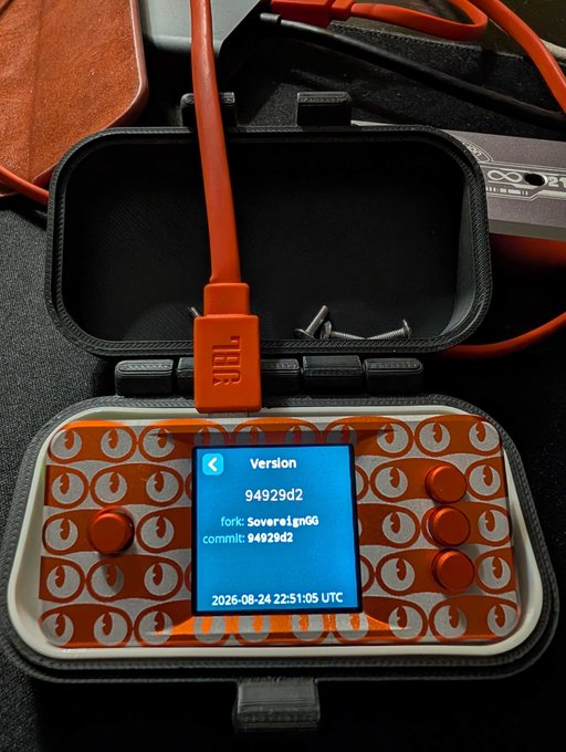 A JBL-branded device in an open carrying case displays version information: 94929d2, fork: Sovere1gnGG, commit: 94929d2, dated 2026-08-24 22:51:05 UTC.