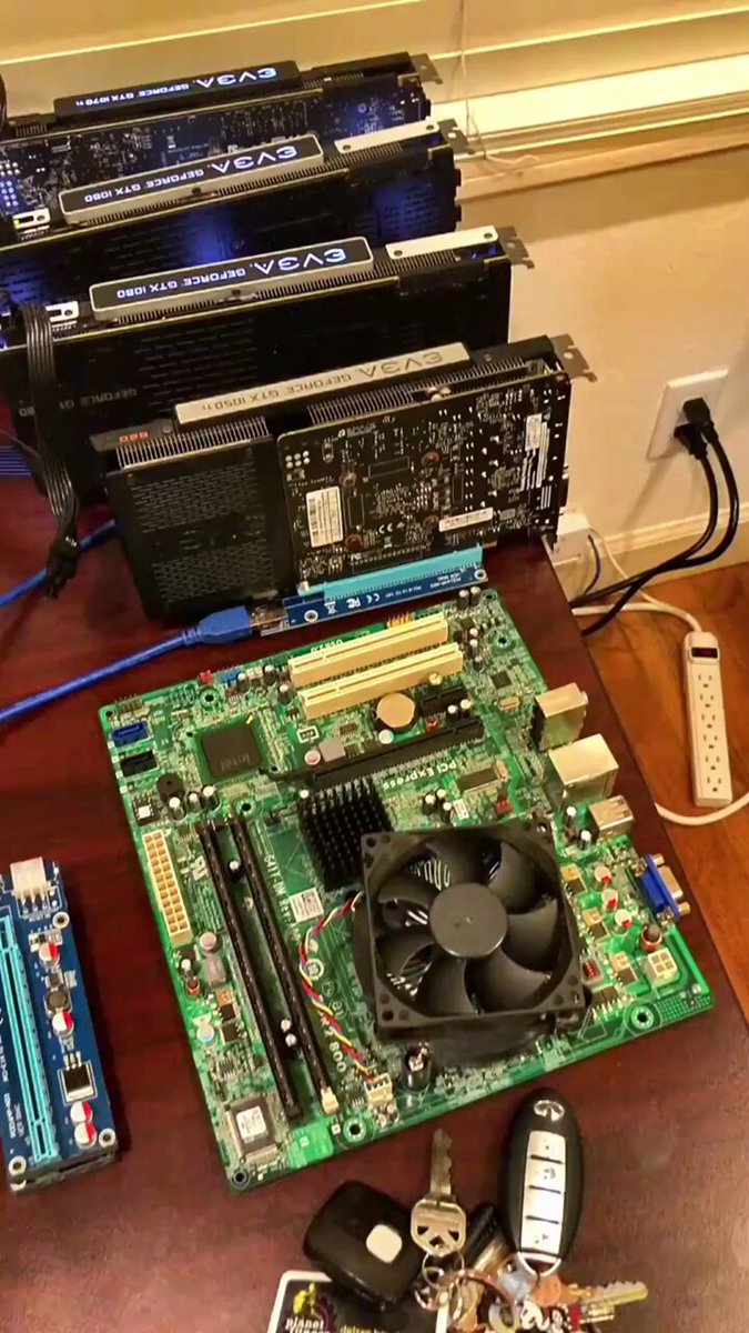 The image shows a computer desk with various electronic gadgets such as multiple computer motherboards (or motherboards), chipsets, and other computer parts laid out on top of it. There are also some used keys lying around. The setting suggests that these items might be associated with an online auction site, where electronic components like graphics cards can be purchased or sold for a reduced price compared to regular retail sales. This might have been done in 2002 when the post was created and is now displayed as a vintage item, indicating its significance from that time period.