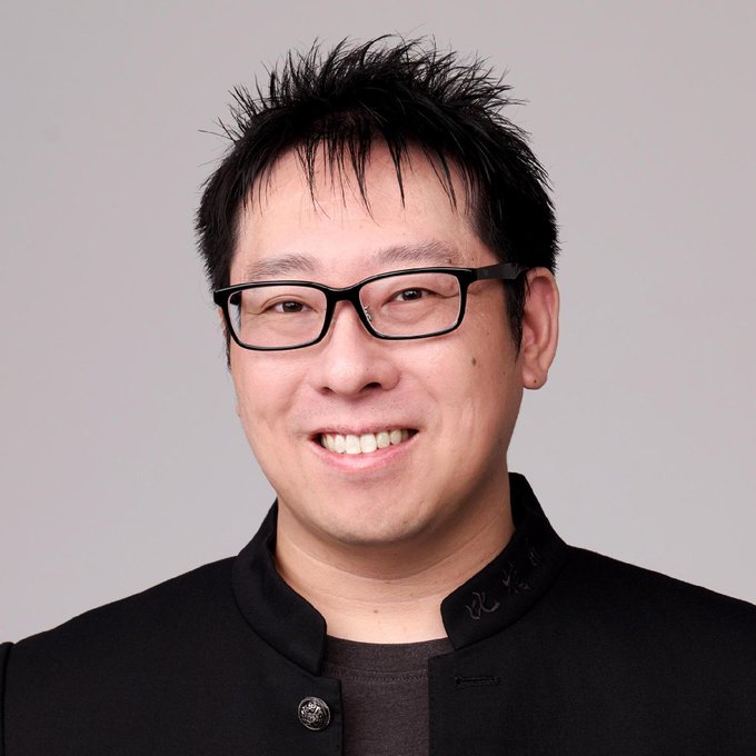A man with short black hair and rectangular glasses smiles while wearing a black jacket over a dark shirt, photographed against a plain gray background. The image appears to be a portrait of Samson Mow, the JAN3 CEO referenced in the post for his critical remarks about Zcash.