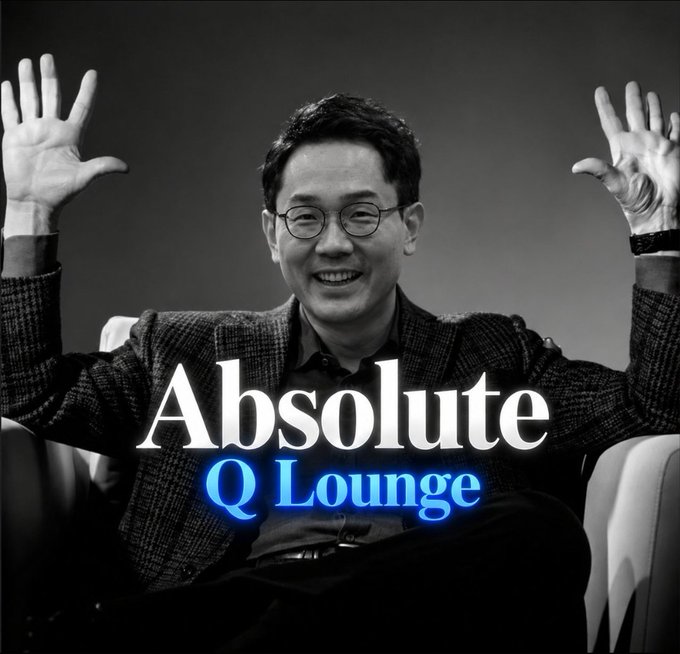 A black-and-white photo of a smiling man in glasses with his hands raised, overlaid with the text 'Absolute Q Lounge' in white and blue.