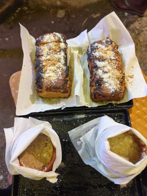 Two grilled sandwiches topped with grated cheese sit on parchment paper in the upper tray, while two small clay bowls containing broth or soup rest in the lower tray on a dark surface. The image of a hearty late-night meal pairs with the post's "Good night" and "builders never stop building" theme, suggesting a warm, nourishing end-of-day snack fueling the creator's continued work with CNPYNetwork.