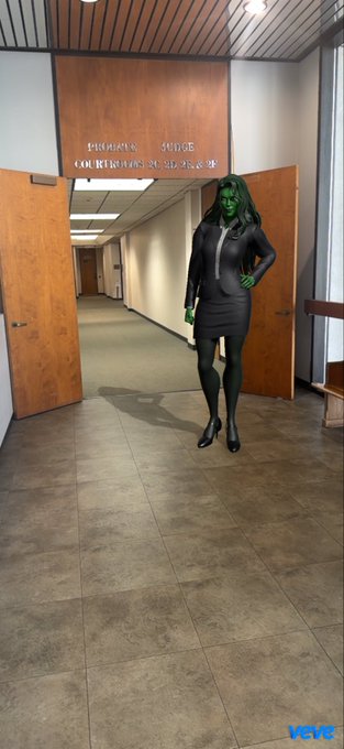 A person wearing a green Hulk mask and a gray business suit stands in the hallway of the "PREPARING JUDGE COURTROOMS 30, 32 AND 38," with a "VEVE" logo in the bottom corner.