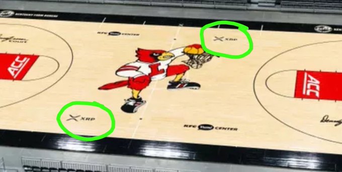 The image shows the Louisville Cardinals basketball court at the KFC Yum! Center, with two green circles highlighting "XRP" logos placed on the court surface near center court. The accompanying post highlights XRP's growing presence "everywhere," pointing out that the cryptocurrency's ticker symbol appears on Louisville Athletics' basketball court alongside the Cardinals mascot logo.