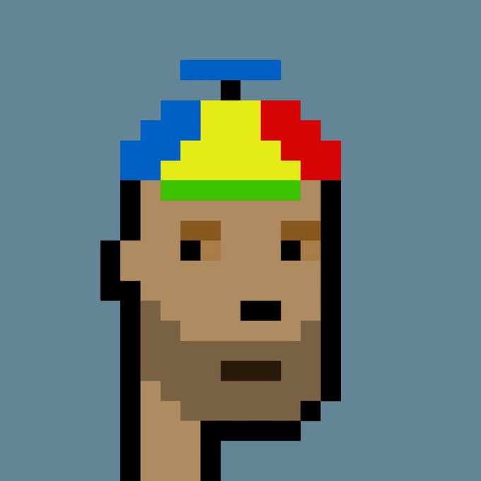 A pixel art portrait of a bald character wearing a propeller beanie hat with blue, yellow, red, and green segments on a gray-blue background.