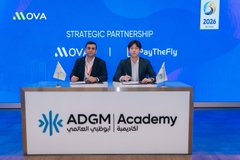 Two people sit at a table signing a 'Strategic Partnership' between MOVA and PythFly at the ADGM Academy (ADGM Authority) event in 2023.