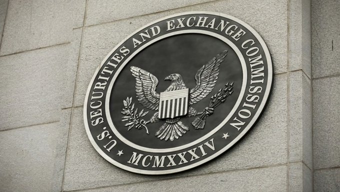 A photograph of the U.S. Securities and Exchange Commission seal mounted on a stone wall, featuring an eagle and the Roman numerals MCMXXXIV.