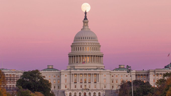 The image features the U.S. Senate building, which has just passed a bill that bans the use of a Federal Reserve Digital Currency for at least four years. The sun is setting behind the Capitol Building, creating a beautiful backdrop for this significant event.