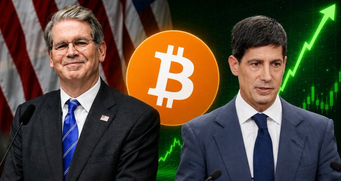 Two men in suits stand on either side of a large orange Bitcoin logo with a green upward-trending chart in the background.