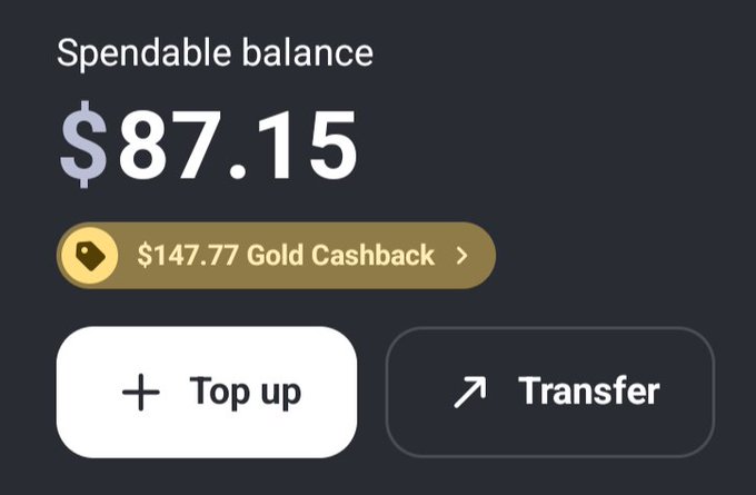 A digital wallet interface displays a spendable balance of $87.15 and $147.77 Gold Cashback, featuring "Top up" and "Transfer" buttons. This illustrates MiniPay's integration of Tether Gold (XAUt0) on Celo, showing how users can now access tokenized gold with cashback rewards directly in their wallets.