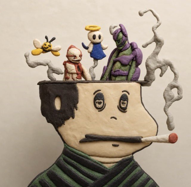 A claymation-style sculpture depicting a figure with a chipped bowl-shaped head holding a cigarette, with various small characters and figures emerging from inside its head.
