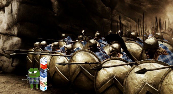 An edited scene from the movie 300 shows Spartan warriors with spears and shields forming a defensive wall, with the Pepe the Frog meme character photoshopped in front of them next to stacked ammo boxes.