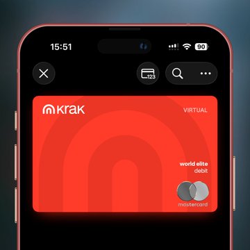 A smartphone displaying a digital Kraken ('krak') virtual World Elite Debit Mastercard on a red background.