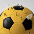 The image shows a yellow and black soccer ball with miniature figures positioned around it, resembling a World Cup scene. The post's text references "Nine years of building" (echoing the meticulous arrangement of the tiny figures) and Binance's partnership with the 2026 FIFA World Cup, with the soccer ball and figures symbolizing the global unity and competition the tournament brings.