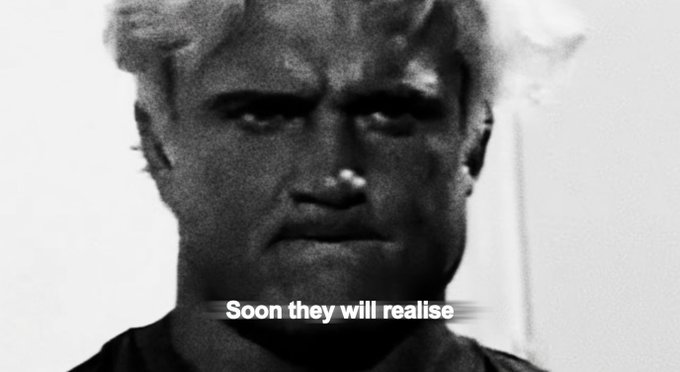 The image shows a close-up of an older man's face, with his eyes looking directly at the camera. The photo has been edited or altered to include text that reads "Soon they will realise", which seems out of place on its own but is placed in front of the original image for emphasis.