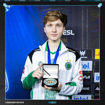 A young male esports player in a green and white jersey holds an MVP award plaque in front of an ESL tournament backdrop.
