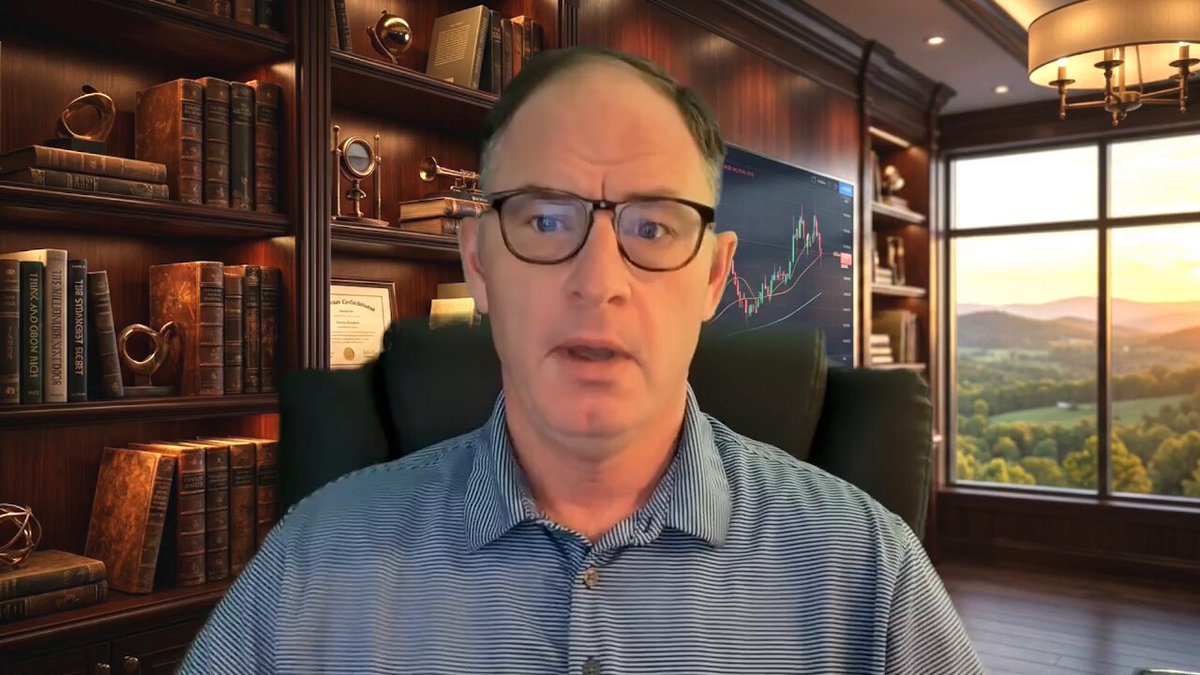 The image shows a man wearing glasses sitting at a desk with several books surrounding him, suggesting he might be an intellectual or involved in research. The background features a window overlooking a beautiful view of mountains, adding a serene atmosphere to the scene. The caption reads "XRP Extreme Surge Model: The Early Warning System Watch The Full Youtube Video Here: youtu.be/hA5a8qL0xJE". This implies that the man might be discussing or researching the XRP extreme surge model and its implications, as indicated by the caption.