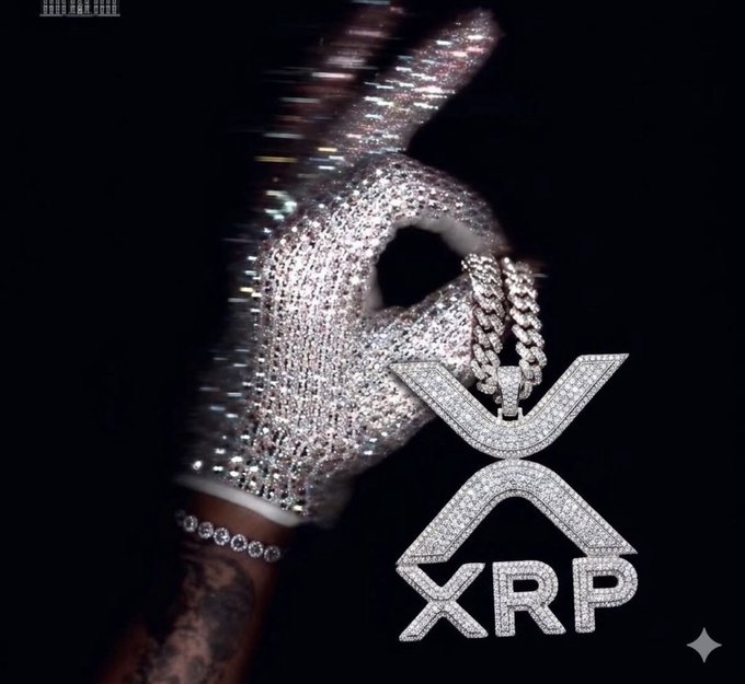 A glitter-covered hand wearing a diamond-studded "XRP" pendant is raised against a black background, visually aligning with the "Gm to all who Gm" Sunday greeting to fellow XRP holders by flexing the cryptocurrency's branding.