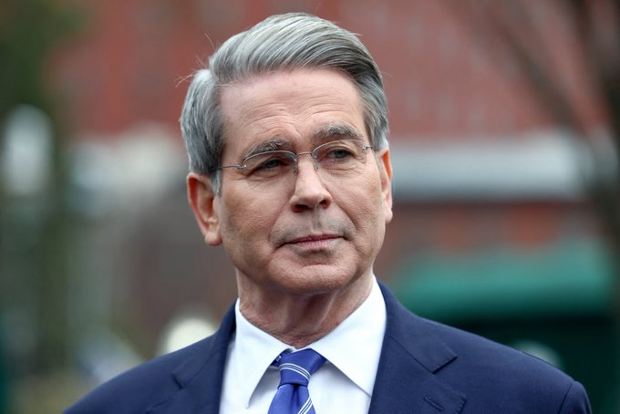 The image features a man wearing a suit and tie with gray hair standing outside of a building. The text in the image reads "CRAZY: The U.S. Treasury says it cannot bail out Bitcoin. Unlike traditional financial institutions, Bitcoin was designed to operate without government support, central bank intervention, or corporate rescue mechanisms. No backstops. No backstops." This statement is related to the man's appearance and attire as he appears to be a well-dressed individual who may have an interest in or knowledge about Bitcoin.