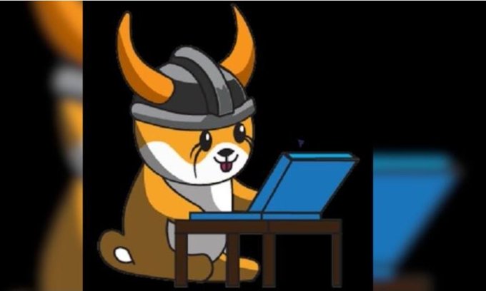 A cartoon illustration of a Shiba Inu dog wearing a Viking helmet and crying while typing on a blue laptop at a small desk.