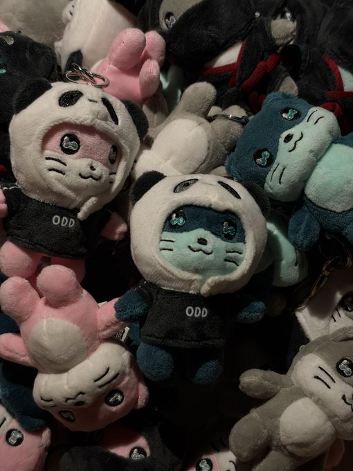 A pile of plush toys featuring characters wearing animal-themed hoods with "ODD" printed on their shirts.
