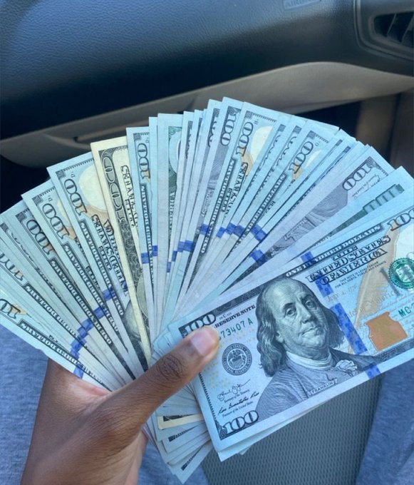 A hand fans out a thick stack of $100 bills featuring Benjamin Franklin, each banded with blue currency straps, while a smaller $1 bill peeks out from the bottom of the pile—a striking visual contradiction to the caption "Money is so hard to come but easy to go... Crazy."