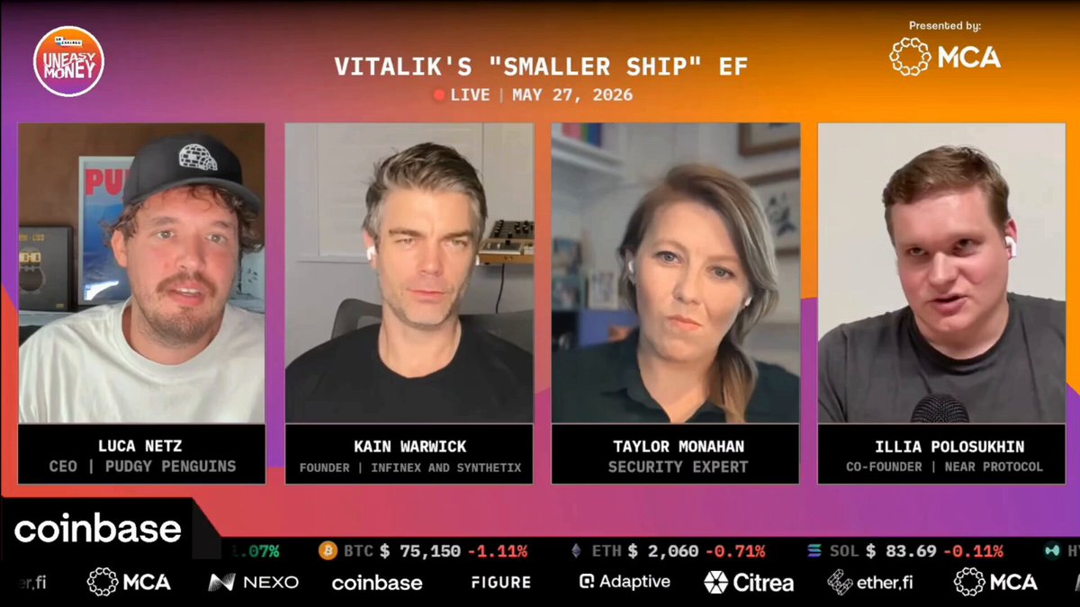 The image shows four people sitting behind a computer screen, with their faces displayed on the screen as they appear to be participating in an online meeting or discussion about cryptocurrency. The background of the image features a purple and orange gradient, which adds visual interest to the scene. The text "coinbase" is also visible within the image.