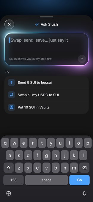 The image shows the "Ask Slush" interface on the Slush Wallet app, featuring a prompt that reads "Swap, send, save... just say it" with example commands like "Send 5 SUI to leo.sui," "Swap all my USDC to SUI," and "Put 10 SUI in Vaults" displayed above an open iOS keyboard.

This visually demonstrates the "Ask Slush" AI-powered feature mentioned in the post, showing how users can simply type natural language commands to execute crypto transactions on the Sui blockchain.