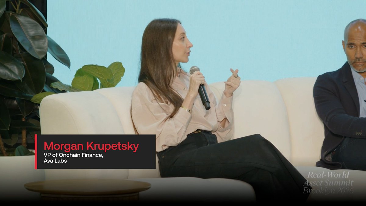 Morgan Krupetsky, VP of Onchain Finance at Ava Labs, speaks into a microphone while sitting on a white couch. Text identifies her name, title, and the event as 'Real-World Asset Summit Brooklyn 2026'.