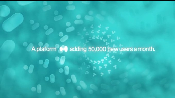 A minimalist teal graphic with floating pill-shaped particles and white text reading 'A platform adding 50,000 new users a month.'