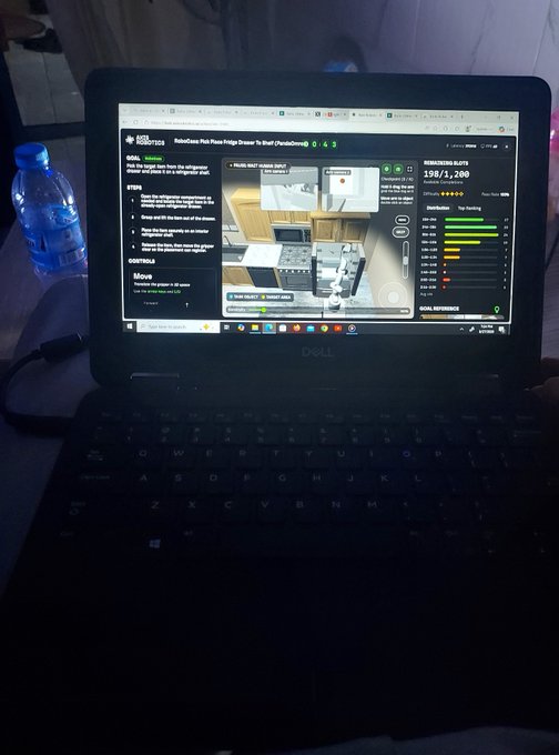 A Dell laptop displays a RoboCase Plinko Prize Fridge Drawer game page on Steam, with a water bottle beside it.