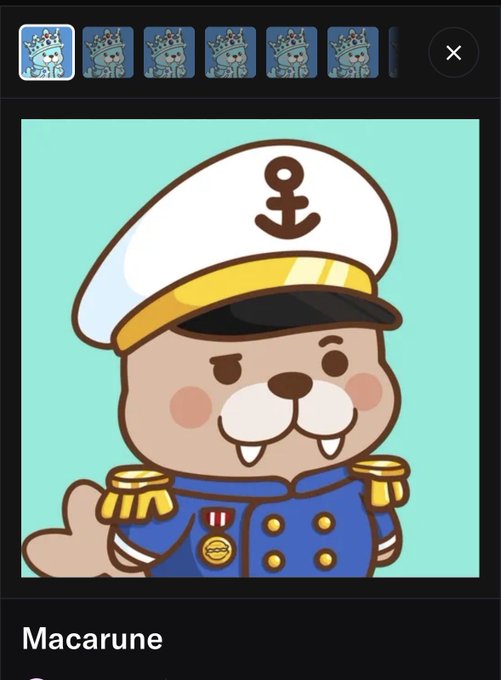 A cartoon illustration of an otter character named 'Macarune' dressed in a blue naval officer's uniform with a white captain's hat featuring an anchor emblem.
