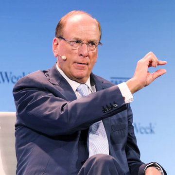 Larry Fink, CEO of BlackRock, gestures while speaking at the Bloomberg Week event, captured mid-discussion with a microphone headset. The image accompanies news that BlackRock clients have sold $54.8 million worth of Bitcoin, likely prompting discussions about the firm's crypto strategy.