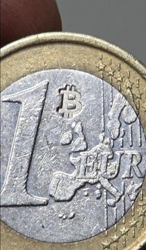 A close-up of a 1 Euro coin with the word "Bitcoin" and the ₿ symbol stamped over its design, visually reinforcing the post's claim that Bitcoiners in Europe are marking Euro coins with Bitcoin stamps.