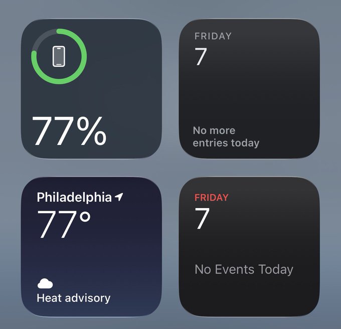 An iPhone home screen showing widgets: 77% battery, Friday the 7th calendar (no entries), Philadelphia weather at 77° with heat advisory, and another Friday the 7th widget showing no events.