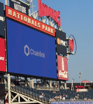 The image shows Nationals Park, home of the Washington Nationals, with a large digital scoreboard prominently displaying the "Chainlink" logo and branding alongside PNC and Coca-Cola advertisements. This visual irony supports the post's point that Chainlink does not actively advertise to the retail public—yet its branding appears on a major MLB stadium scoreboard, highlighting a contradiction regarding the "Strategic Initiatives" mentioned in the caption.