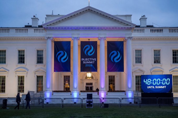 The White House is illuminated at dusk with blue banners reading 'INJECTIVE SUMMIT 2026' hanging from the columns, while a digital countdown displays '48:00:00 UNTIL SUMMIT'.