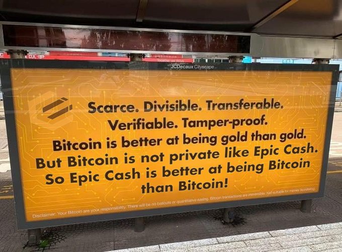 An orange billboard advertisement reading 'Scarce. Divisible. Transferable. Verifiable. Tamper-proof. Bitcoin is better at being gold than gold. But Bitcoin is not private like Epic Cash. So Epic Cash is better at being Bitcoin than Bitcoin!', with a disclaimer at the bottom.