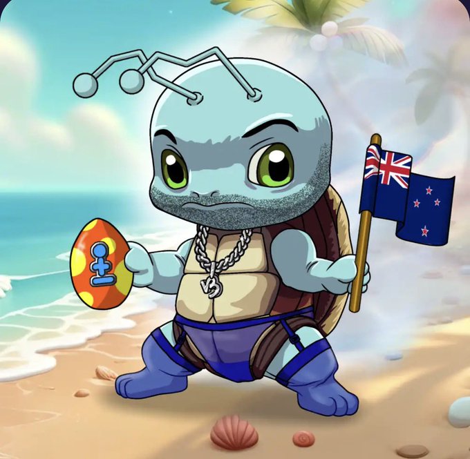 A cartoonish blue turtle character with muscular arms, holding a New Zealand flag and a colorful egg, standing on a beach with the ocean in the background.