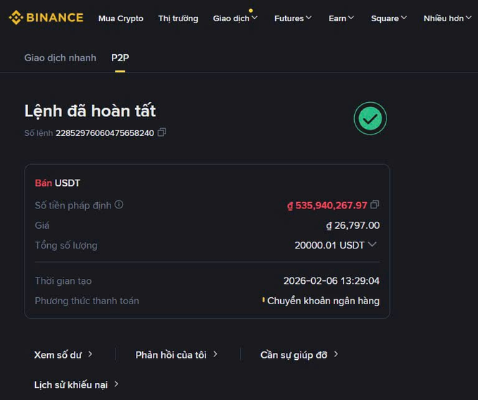 A Binance P2P order completion screen showing a successful USDT sale of 20000.01 USDT at ₫26,797.00 per USDT (total ₫535,940,267.97) via bank transfer, completed on 2026-02-06 at 13:29:04.