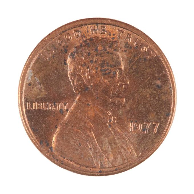 Close-up photograph of the obverse of a 1977 U.S. Lincoln penny, showing Abraham Lincoln in profile with the inscriptions 'IN GOD WE TRUST' and 'LIBERTY' and the date 1977.