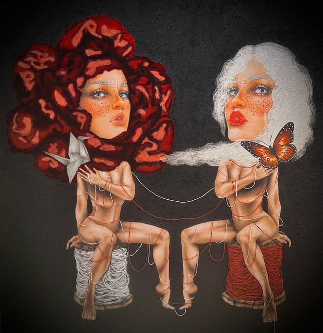 A surreal digital artwork features two seated female figures with exaggerated hair—one red like yarn roses, one white and fluffy—with their bodies wrapped in red and white threads, sitting on spools, accompanied by a butterfly and origami crane.