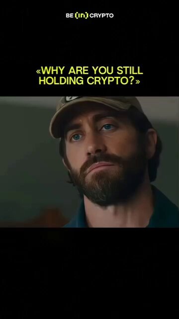 The image features a man with a beard wearing a baseball cap, looking up at something or someone. Below him, there's text that reads "Why are you still holding crypto?" The caption also includes an image of a man's face with a question mark above and below it.
